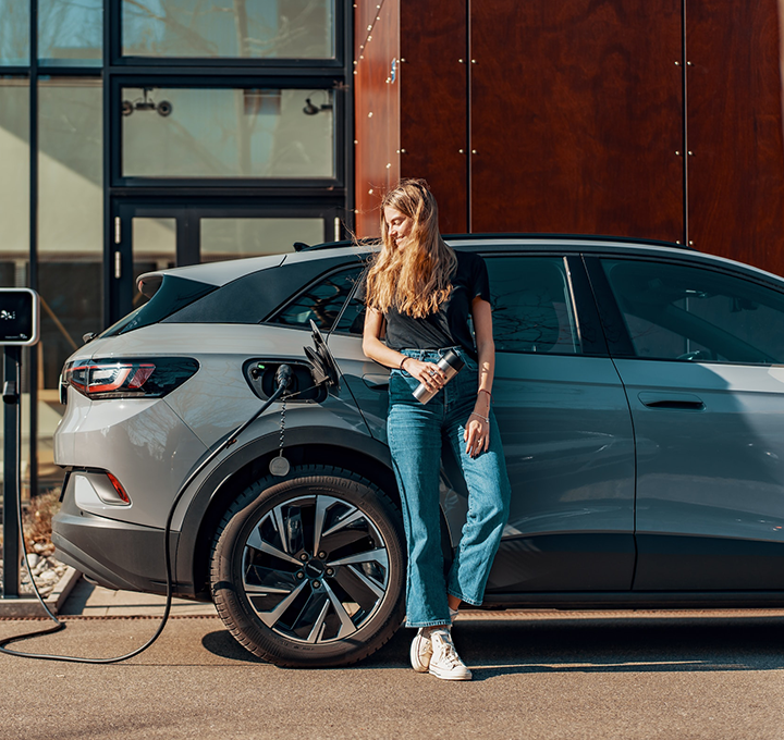 Woman waiting for her car to charge